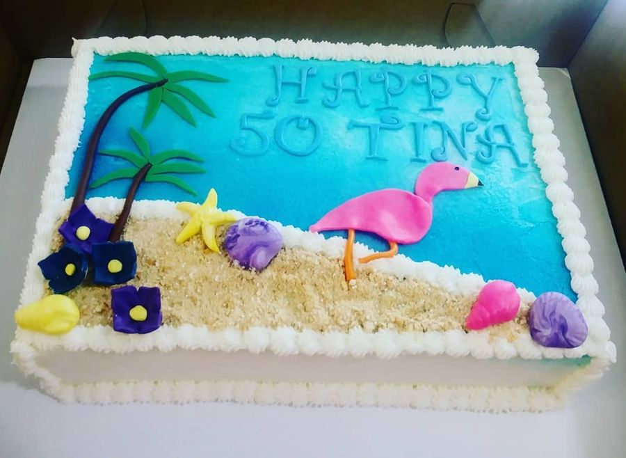 Happy 50 beach sheet cake with a flamingo, palm trees and seashells